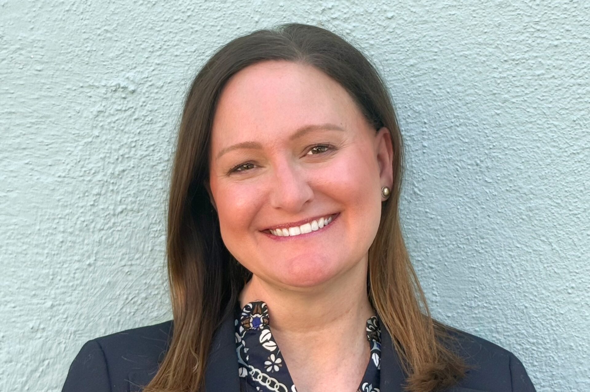 Professional headshot of Joanne Hilliard, Client Service Associate at Meridian Financial Partners, smiling in a professional setting.
